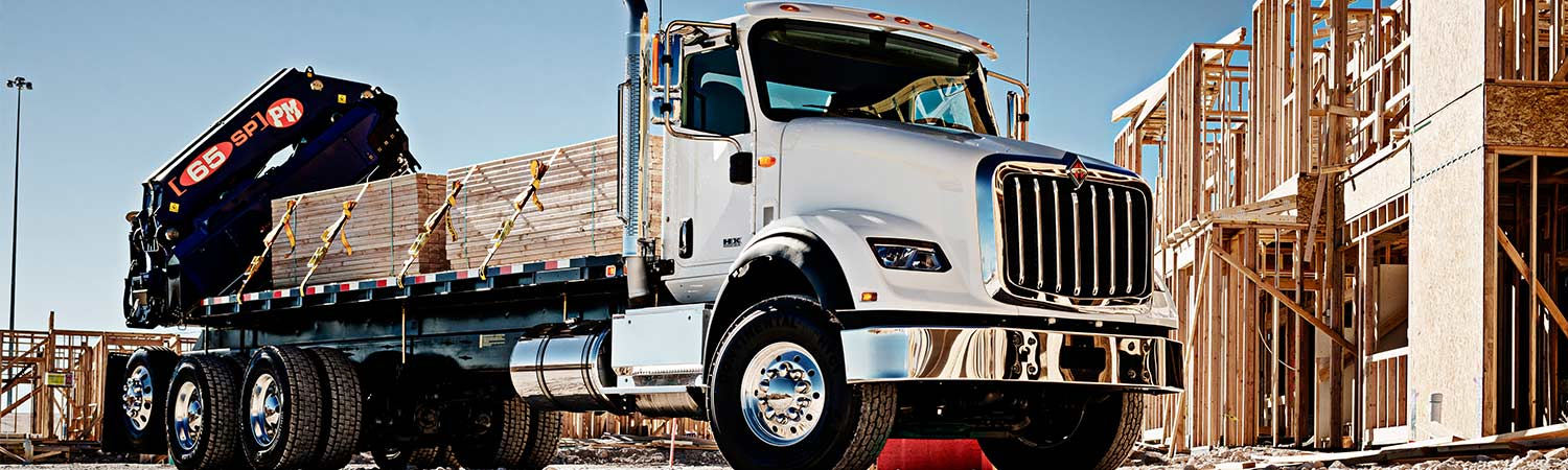 2017 International® HX™ truck hauling lumber at a construction site