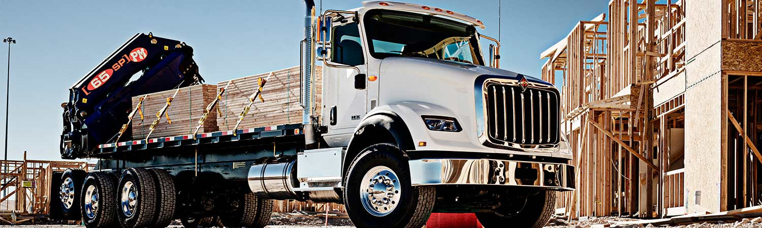 2017 International® HX™ truck hauling lumber at a construction site
