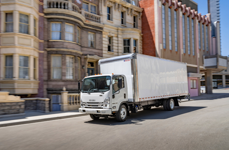 2020 Isuzu Trucks NPR-HD Diesel truck unloading gravel in a worksite.